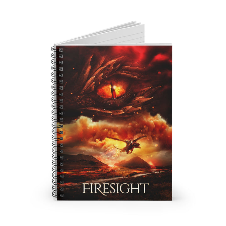 A notebook with the cover featuring the artwork from the cover of Firesight. Artwork features a red dragon eye at the top. Below the eye, the two main characters ride on a dragon over a volcano erupting. The title is at the bottom of the notebook cover.