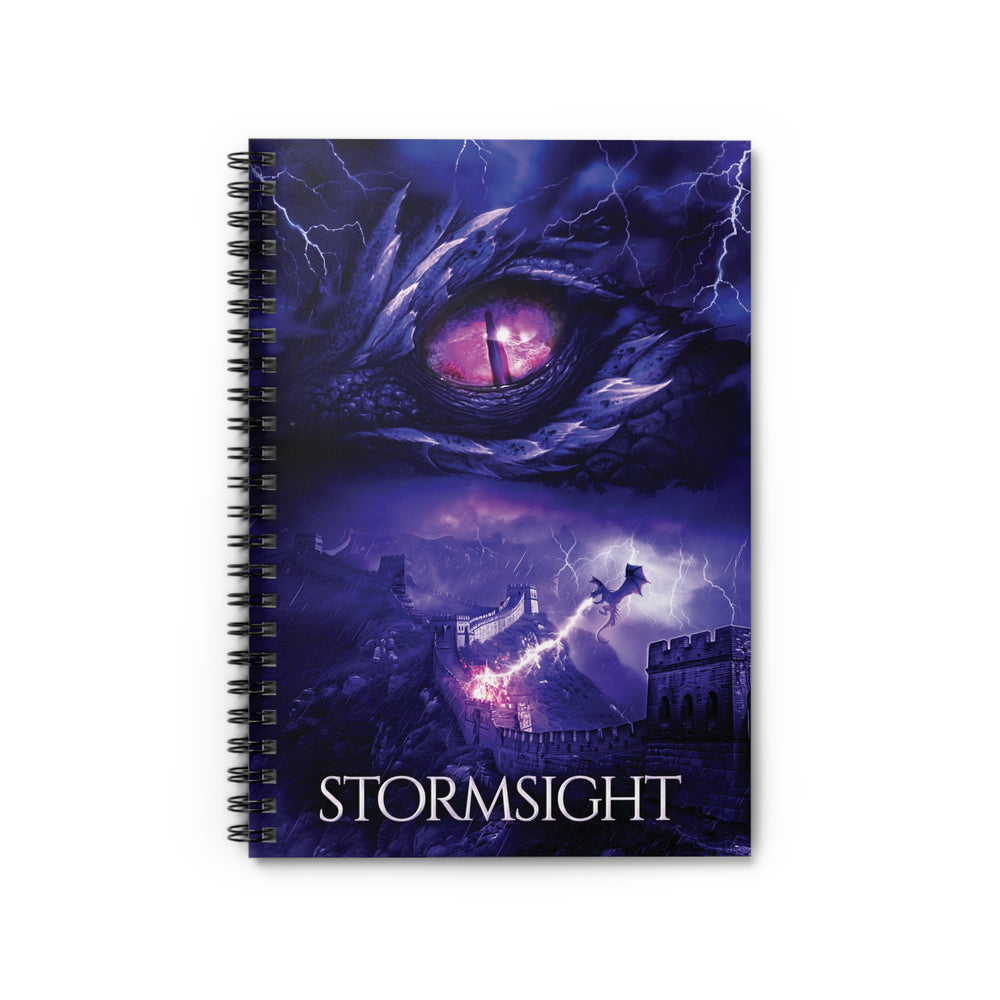 A notebook with the cover featuring the artwork from the cover of Stormsight. Artwork features a purple dragon eye at the top. Below the eye, a dragon breathes lightning onto a wall. The title is at the bottom of the notebook cover.