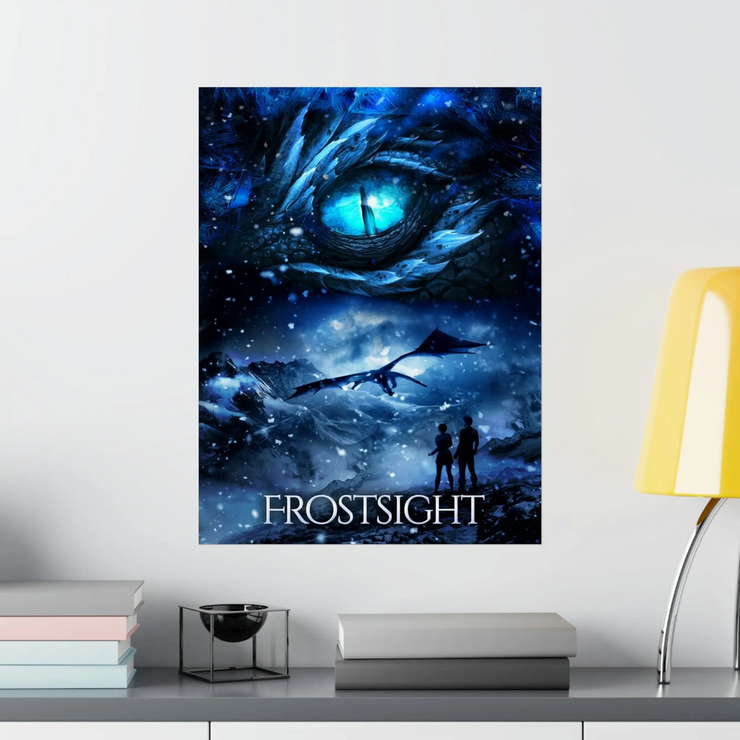 A poster hanging on a wall featuring the artwork from the cover of Frostsight. Artwork features a blue dragon eye at the top. Below the eye, the two main characters watch a dragon in the distance in a snowy mountain landscape. The title is at the bottom of the poster.