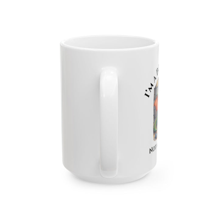 Side view of a white mug. Design on the mug reads "I'm a book dragon not a book worm." Between the text is a watercolor design of a dragon reading next to a stack of books.