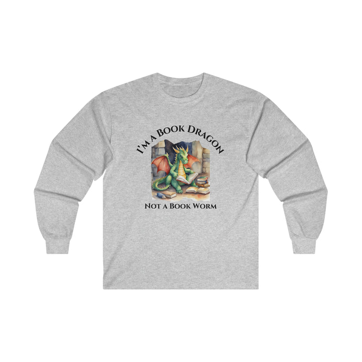 A long sleeve heather gray t-shirt. Design on the shirt reads "I'm a book dragon not a book worm." Between the text is a watercolor design of a dragon reading next to a stack of books.