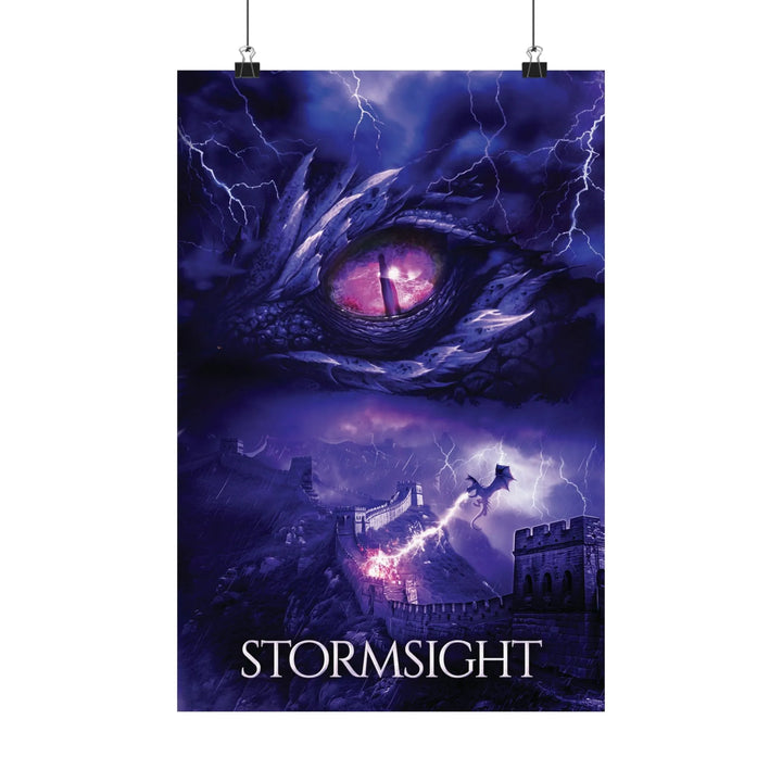 A poster featuring the artwork from the cover of Stormsight. Artwork features a purple dragon eye at the top. Below the eye, a dragon breathes lightning onto a wall. The title is at the bottom of the notebook cover.