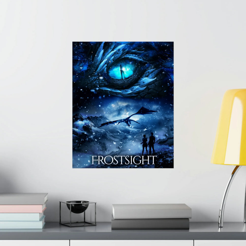 A poster hanging on a wall featuring the artwork from the cover of Frostsight. Artwork features a blue dragon eye at the top. Below the eye, the two main characters watch a dragon in the distance in a snowy mountain landscape. The title is at the bottom of the poster.