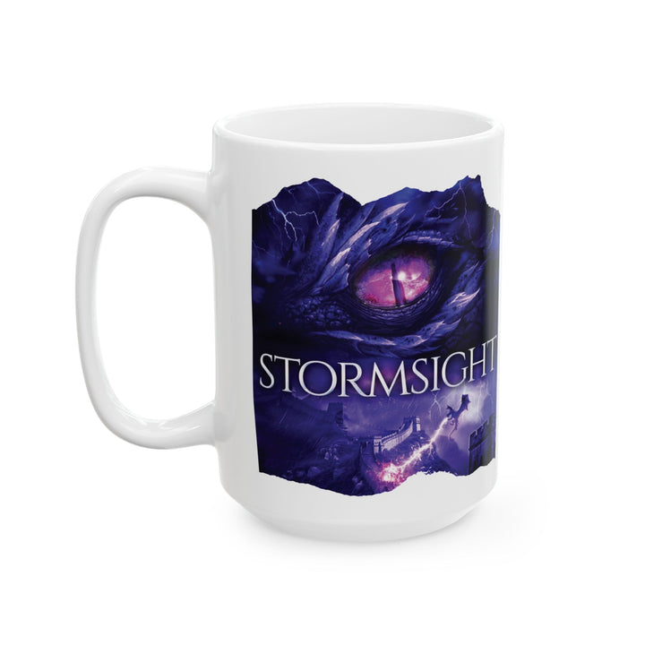 A white mug. Design on the mug is the cover of Stormsight, just showing the purple dragon eye and the title with the a dragon breathing lightning onto a wall.