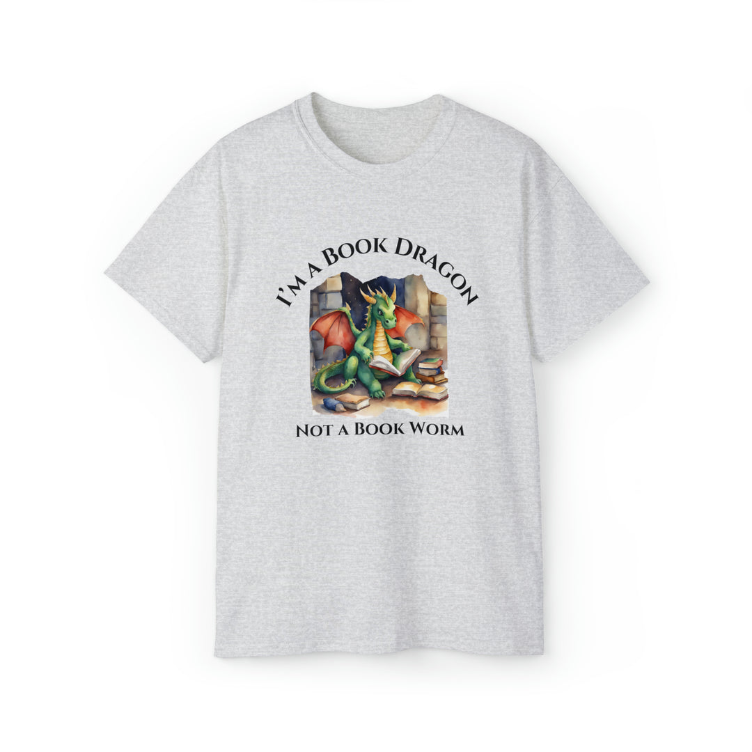 A short sleeve heather gray t-shirt. Design on the shirt reads "I'm a book dragon not a book worm." Between the text is a watercolor design of a dragon reading next to a stack of books.