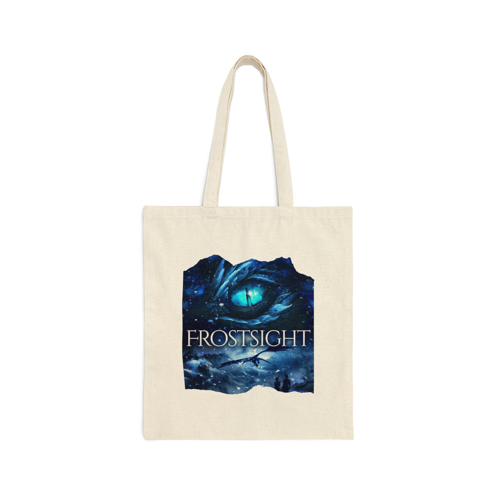 A tan canvas tote bag. Design on the tote bag is the cover of Frostsight, just showing the blue dragon eye and the title with the two main characters watching the dragon in the snowy mountain landscape.