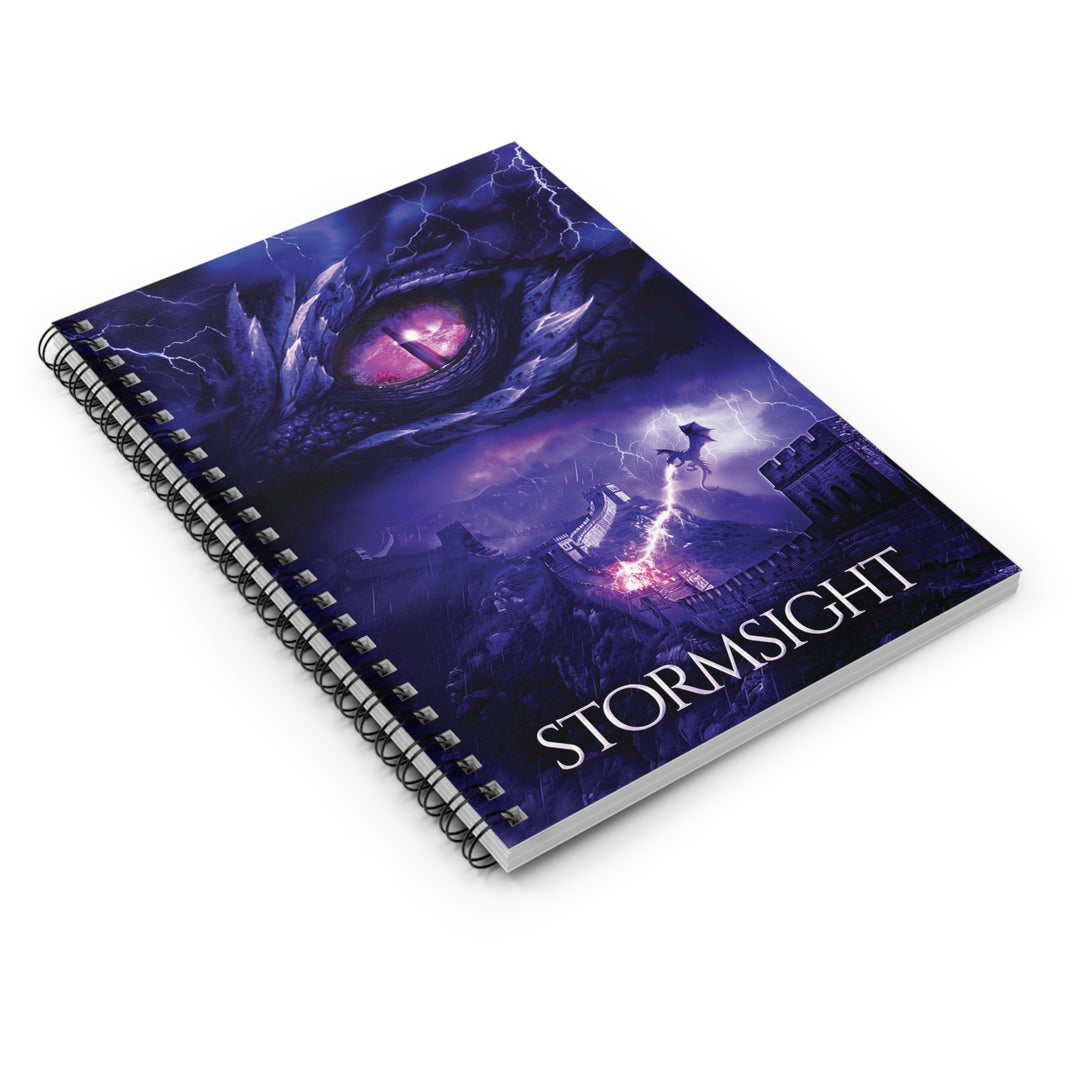 A notebook with the cover featuring the artwork from the cover of Stormsight. Artwork features a purple dragon eye at the top. Below the eye, a dragon breathes lightning onto a wall. The title is at the bottom of the notebook cover.