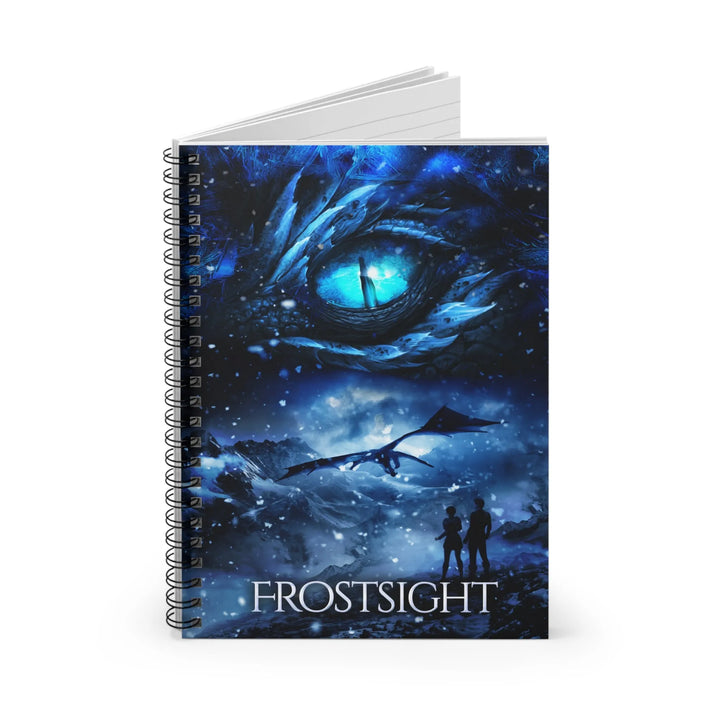 A notebook with a cover featuring the artwork from the cover of Frostsight. Artwork features a blue dragon eye at the top. Below the eye, the two main characters watch a dragon in the distance in a snowy mountain landscape. The title is at the bottom of the notebook cover.