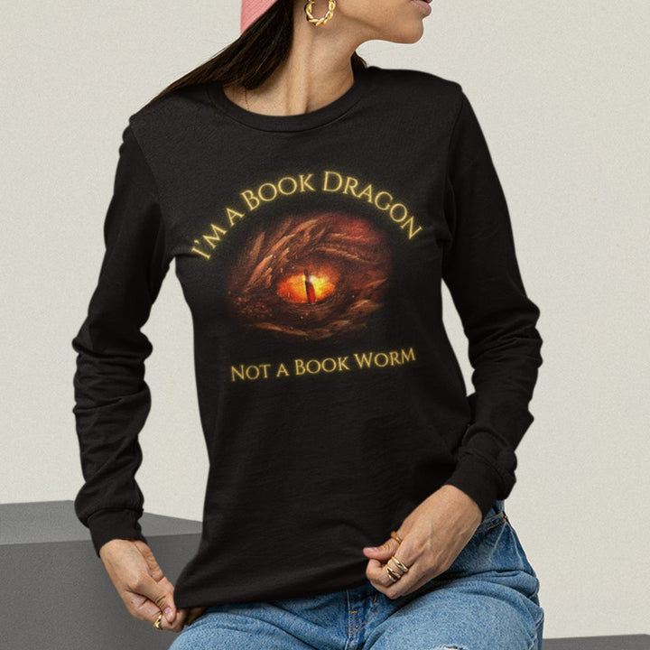 A woman wearing a long sleeve black t-shirt. Design on the shirt reads "I'm a book dragon not a book worm." Between the text is the red dragon eye from the cover of Firesight.