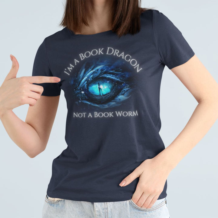 A woman wearing a short sleeve navy t-shirt. Design on the shirt reads "I'm a book dragon not a book worm." Between the text is the blue dragon eye from the cover of Frostsight.