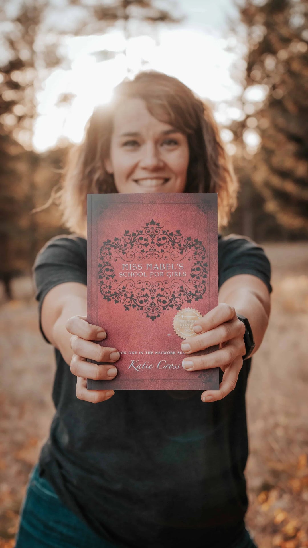 Katie Cross holding one of her books