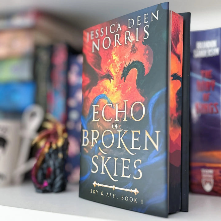 Book titled 'Echo of Broken Skies' by Jessica Deen Norris on a shelf with blurred books in the background.#autograph-option_unsigned