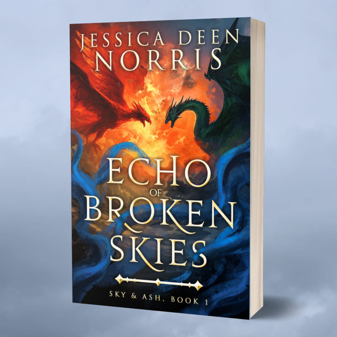 Paperback - Echo of Broken Skies by Jessica Deen Norris - Cover features the author's name at the top in large serif font. The central artwork depicts a dramatic sky divided by swirling clouds of fire. On the left, a red phoenix with outstretched wings flies toward a dark green dragon on the right, both poised as if mid-battle. Blue, smoky tendrils swirl around the bottom half of the image. The title is centered in bold, metallic gold, with "Sky & Ash, Book 1" below a decorative gold divider.