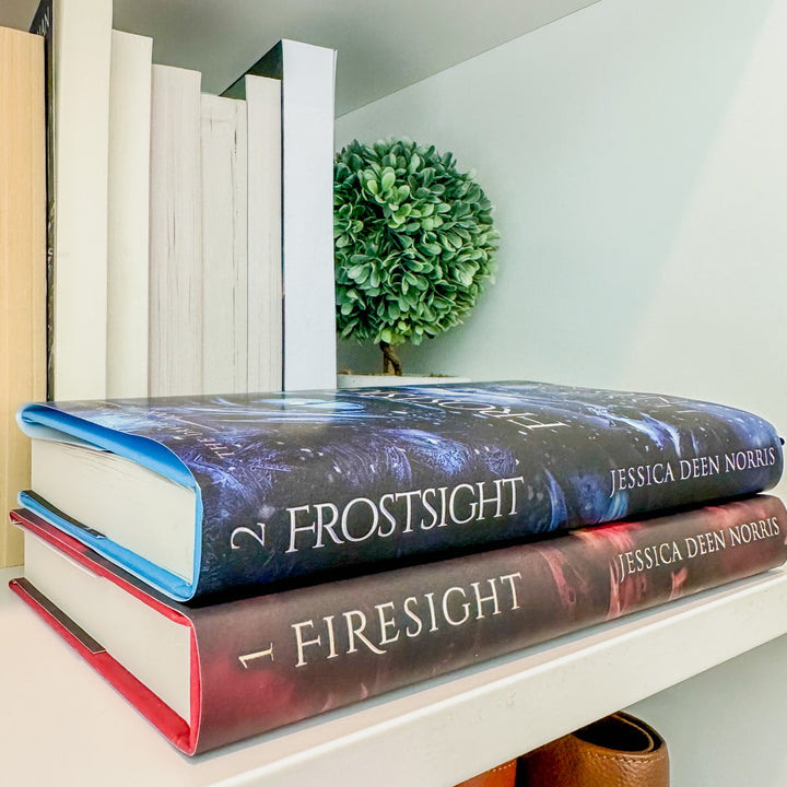Firesight & Frostsight hardcovers shown stacked on a bookshelf