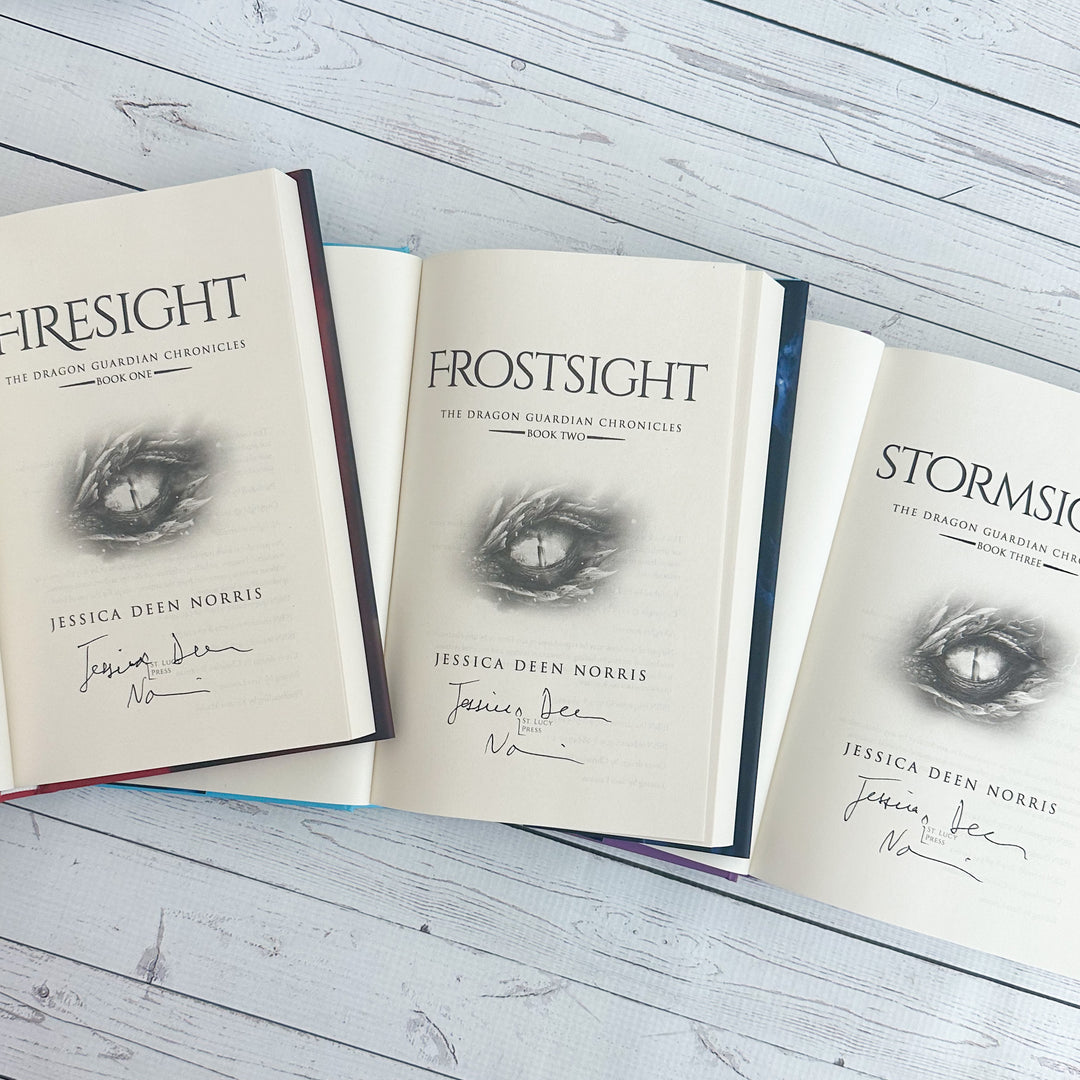 Firesight, Frostsight, and Stormsight hardcovers open to the title page with the author's signature