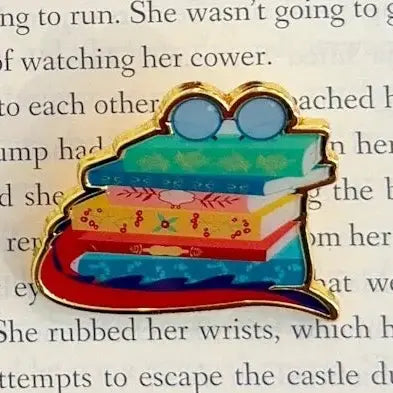 Pin with books and glasses on a text background