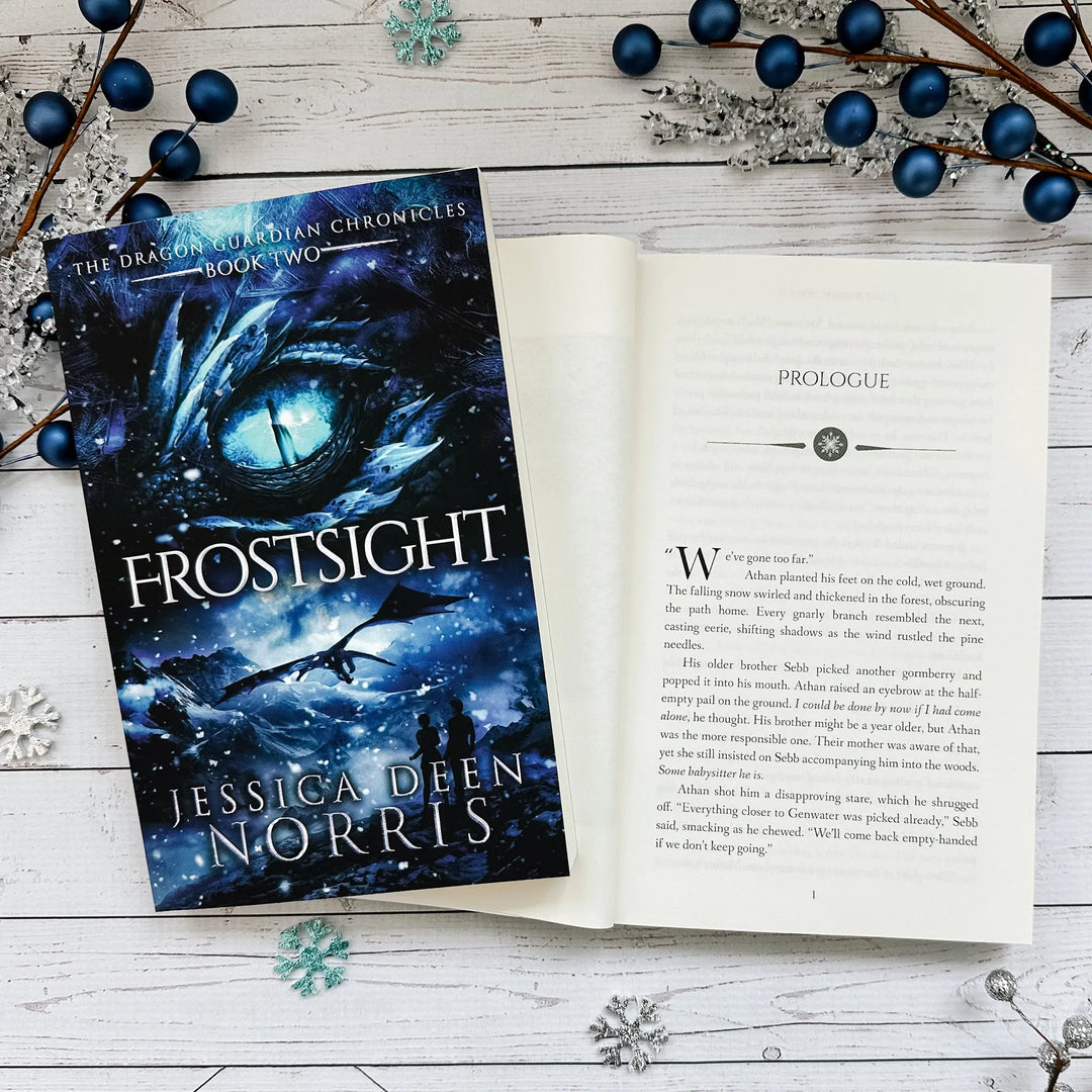 Frostsight book cover and another copy open to the first page of the prologue (which can be read on the product page below the image)#autograph-option_unsigned