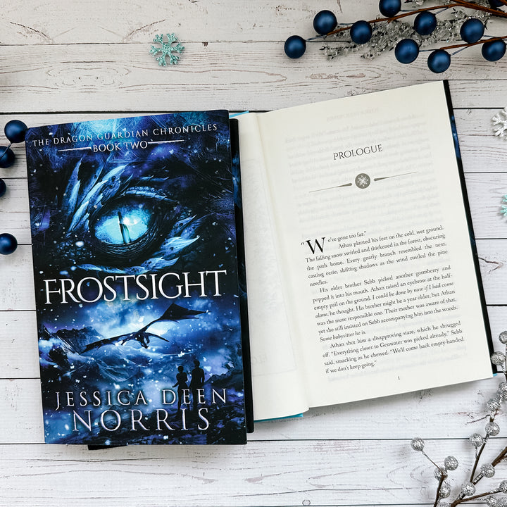 Frostsight book cover and another copy open to the first page of the prologue (which can be read on the product page below the image)