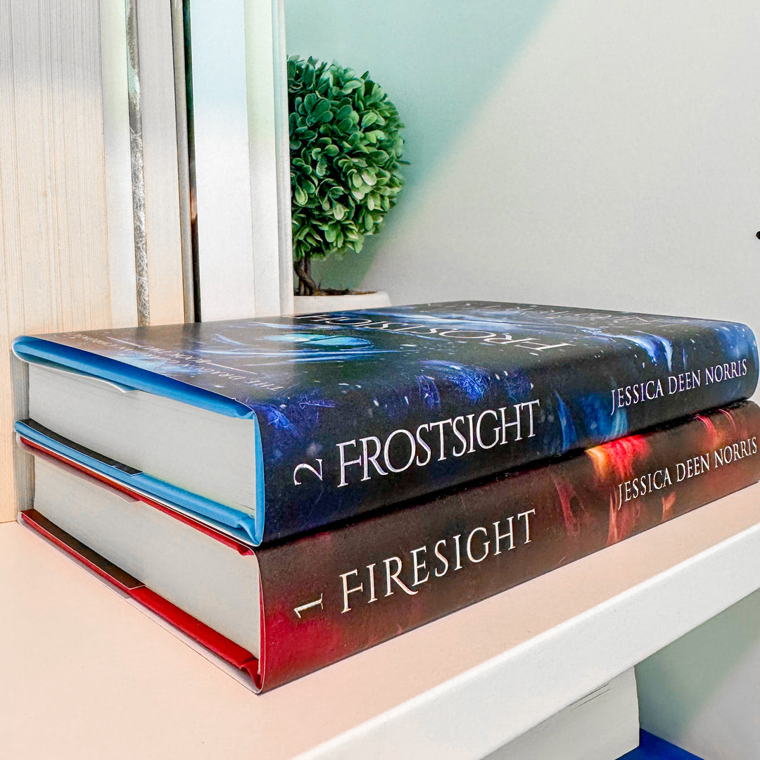 Firesight & Frostsight hardcovers shown stacked on a bookshelf