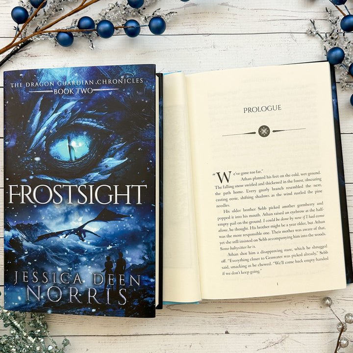 Frostsight book cover and another copy open to the first page of the prologue (which can be read on the product page below the image)#autograph-option_unsigned