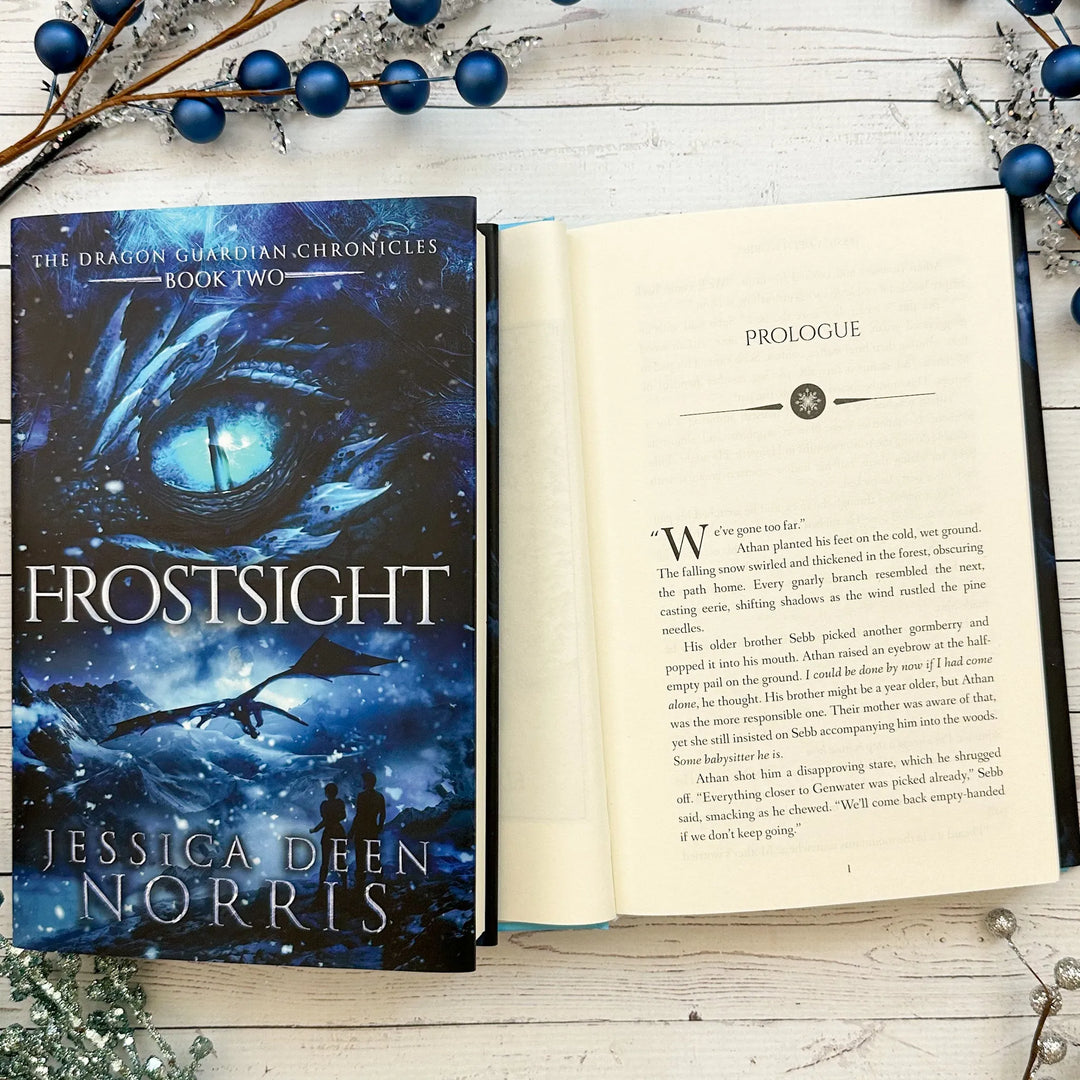 Frostsight book cover and another copy open to the first page of the prologue (which can be read on the product page below the image)#autograph-option_signed-by-author