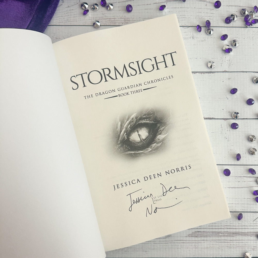 Stormsight open to the title page with the author's signature