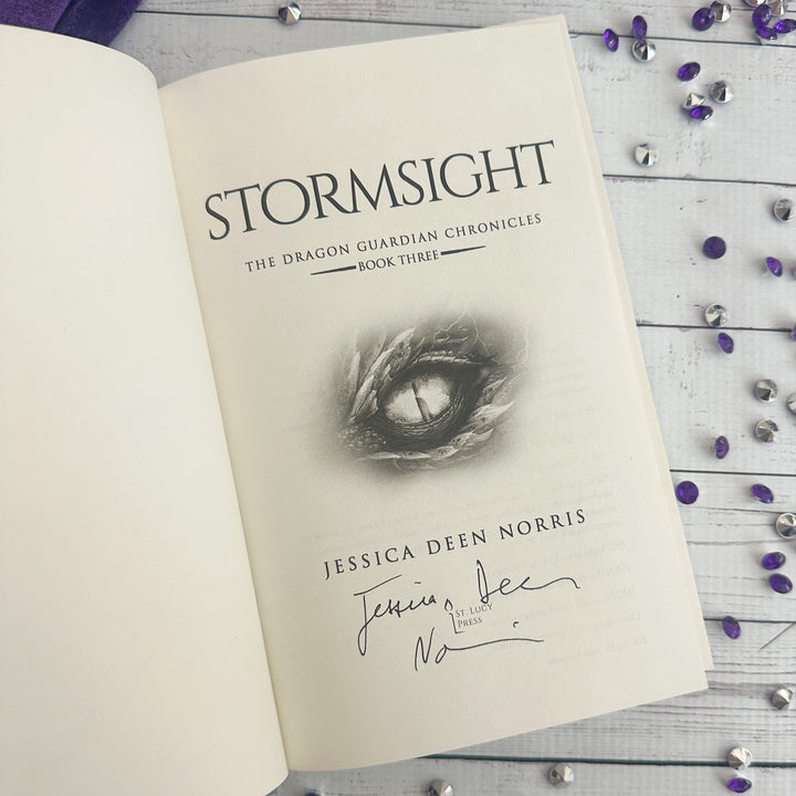 Stormsight open to the title page with the author's signature