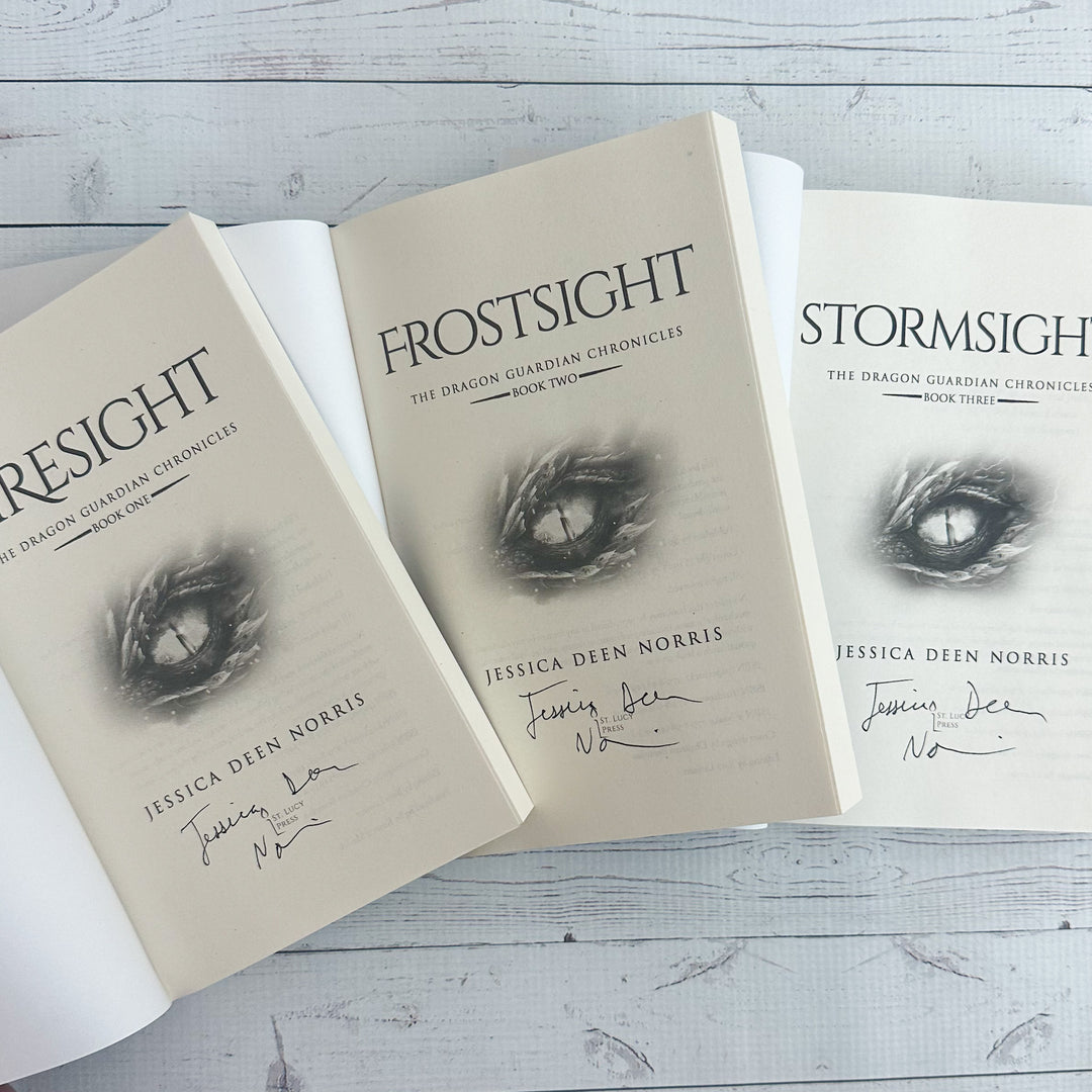 Firesight, Frostsight, and Stormsight paperbacks open to the title page with the author's signature