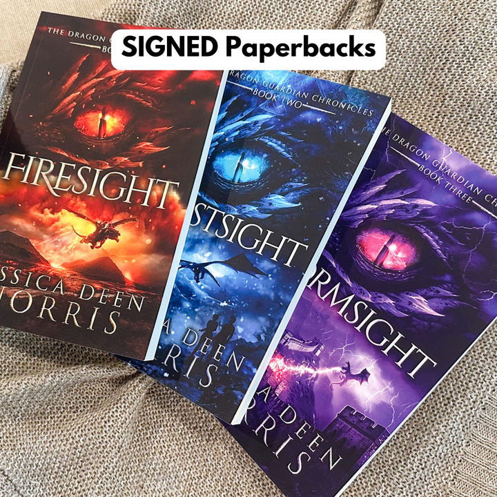 Firesight, Frostsight, and Stormsight paperbacks laid out next to each other. These books are signed by the author.