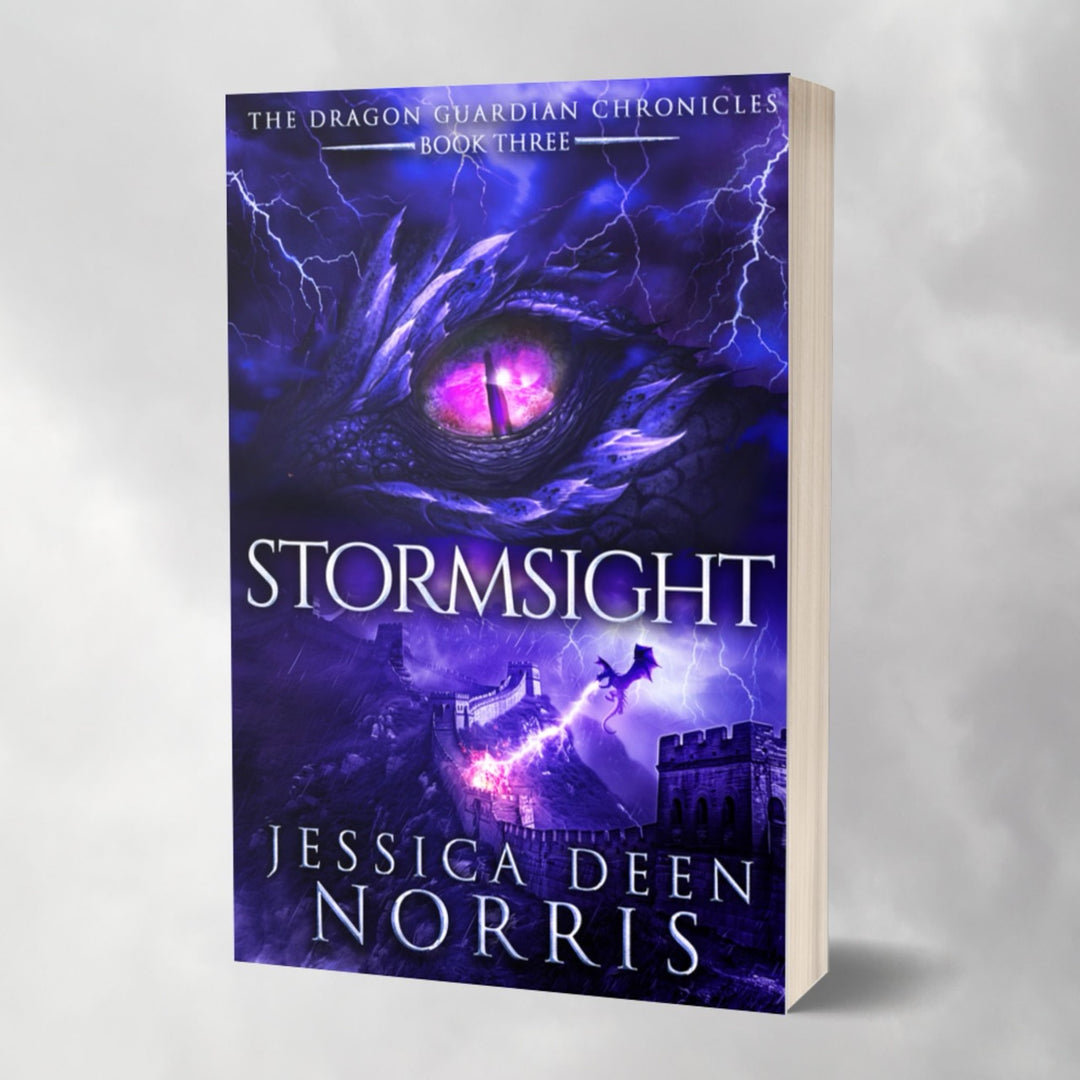 Mockup of a paperback book for Stormsight. Cover features the title across the middle with a purple dragon eye and "The Dragon Guardian Chronicles Book 3" above it. Below the title, a dragon breathes lightning onto a huge stone wall. The author's name is at the bottom of the cover.